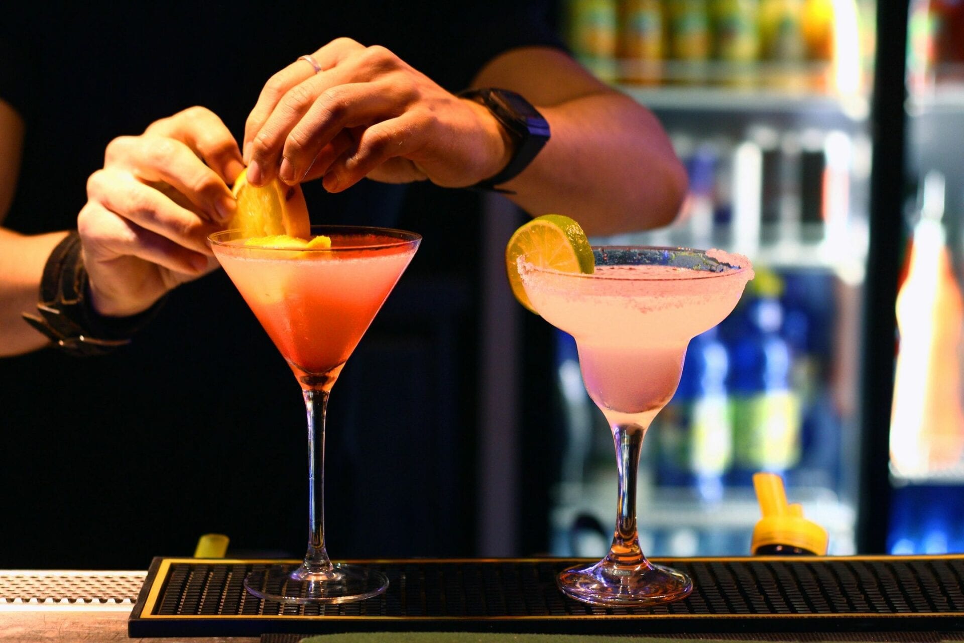 A person is preparing to serve two drinks.