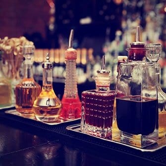 A table with several different bottles of alcohol.