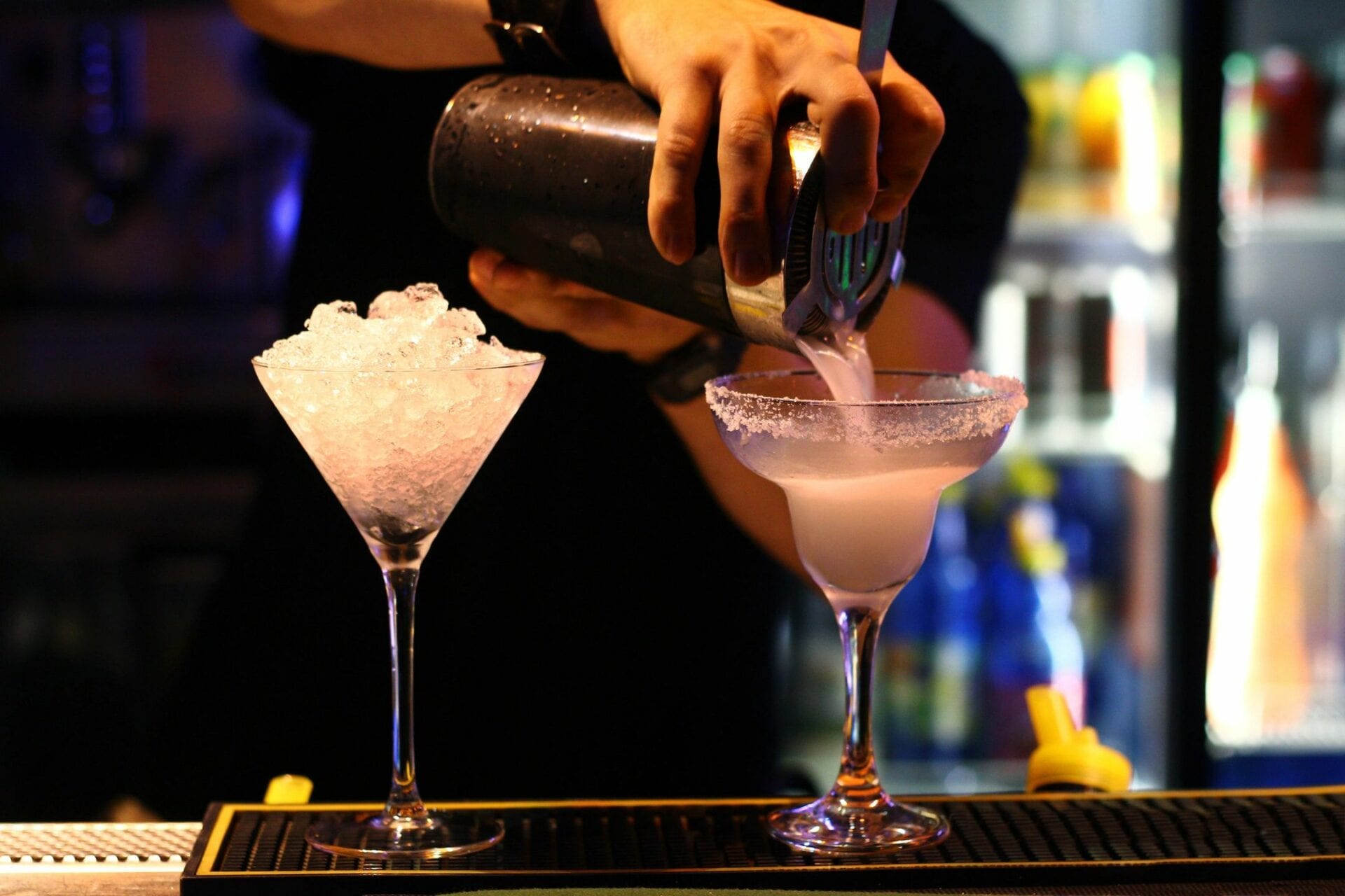 A person pouring liquid into a glass